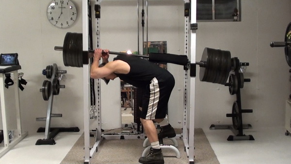 Donkey Calf Raise in the rack with a barbell