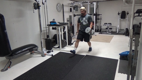 Pass-Under Walking Lunges With a Dumbbell