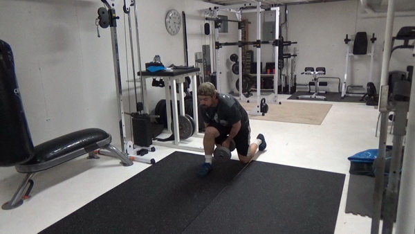 Pass-Under Walking Lunges With a Dumbbell