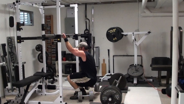 One-Arm Gripping Dumbbell Squats